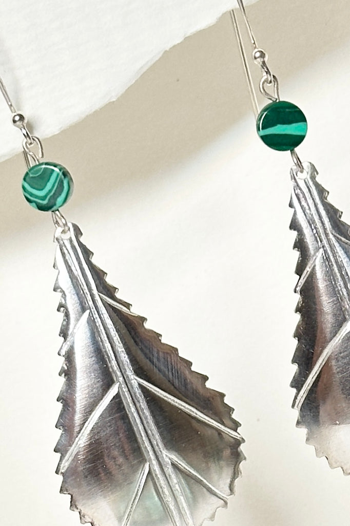 These African style leaf shaped earrings were designed in Mozambique, East Africa, exclusively for Mombasa Rose. In 925 silver, there is a small Malachite bead at the top.