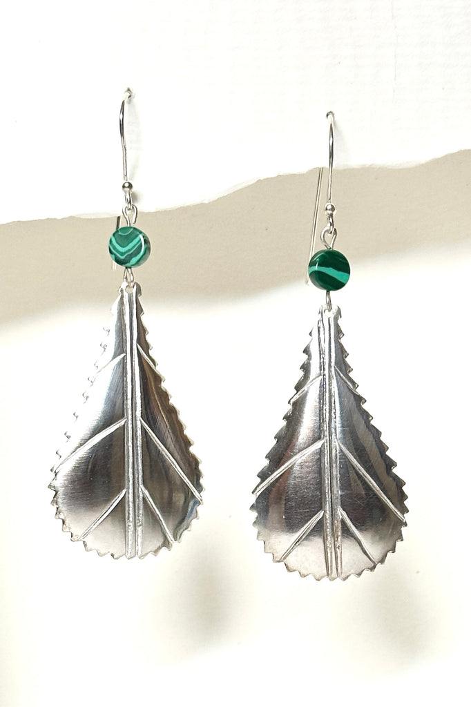These African style leaf shaped earrings were designed in Mozambique, East Africa, exclusively for Mombasa Rose. In 925 silver, there is a small Malachite bead at the top.