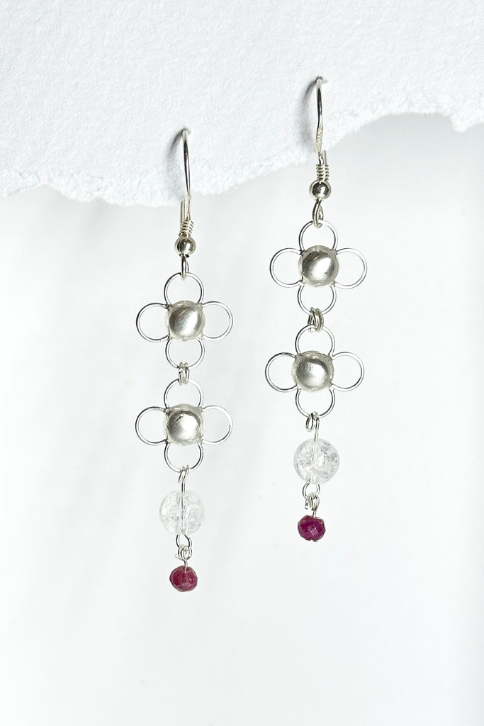 These tiny pretty and delicate 925 silver chainmaille earrings are made from lightweight daisy shaped links, linked together with small rings. They are as light as a feather and beautiful to wear. There is a tiny ruby bead that swings from the bottom.