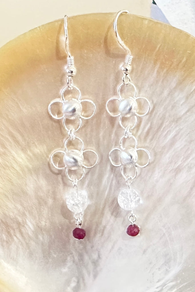 These tiny pretty and delicate 925 silver chainmaille earrings are made from lightweight daisy shaped links, linked together with small rings. They are as light as a feather and beautiful to wear. There is a tiny ruby bead that swings from the bottom.