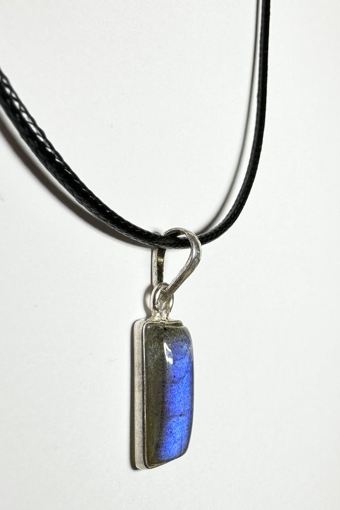 This tiny Labradorite pendant has a flash of bright blue down one side but is a quiet stone from other angles, it is a natural semi precious stone