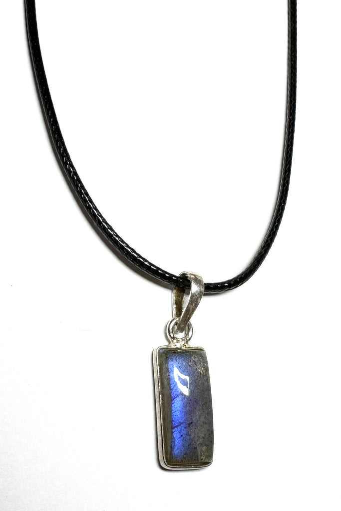 This tiny Labradorite pendant has a flash of bright blue down one side but is a quiet stone from other angles, it is a natural semi precious stone