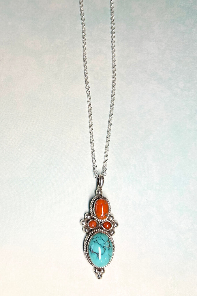 This stunning vintage pendant is an old piece that has a "village make" feel to it. Hand made, with a centre cabochon of natural turquoise and old coral set in 925 silver this pendant has a really lovely feel to it, with no signs of wear.