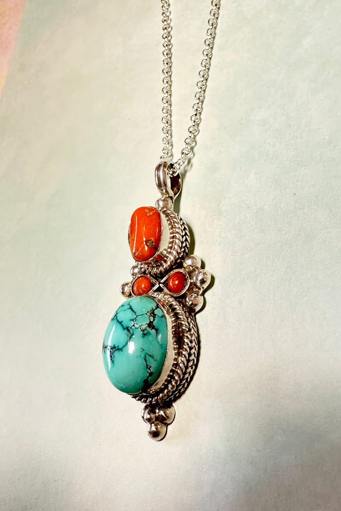 This stunning vintage pendant is an old piece that has a "village make" feel to it. Hand made, with a centre cabochon of natural turquoise and old coral set in 925 silver this pendant has a really lovely feel to it, with no signs of wear.