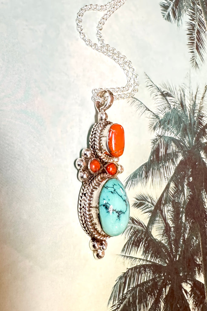 This stunning vintage pendant is an old piece that has a "village make" feel to it. Hand made, with a centre cabochon of natural turquoise and old coral set in 925 silver this pendant has a really lovely feel to it, with no signs of wear.