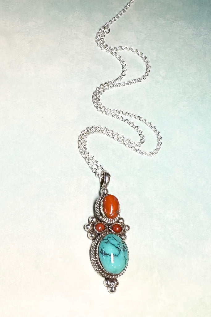 This stunning vintage pendant is an old piece that has a "village make" feel to it. Hand made, with a centre cabochon of natural turquoise and old coral set in 925 silver this pendant has a really lovely feel to it, with no signs of wear.