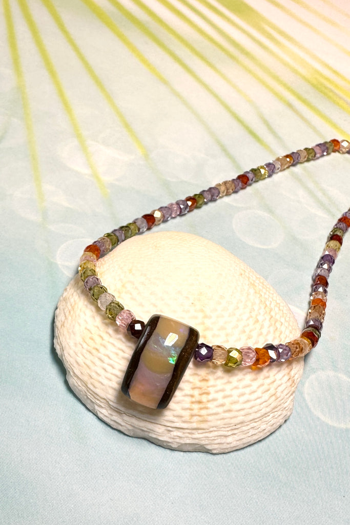 The Australian boulder opal pendant necklace is strung with very tiny faceted gemstones.