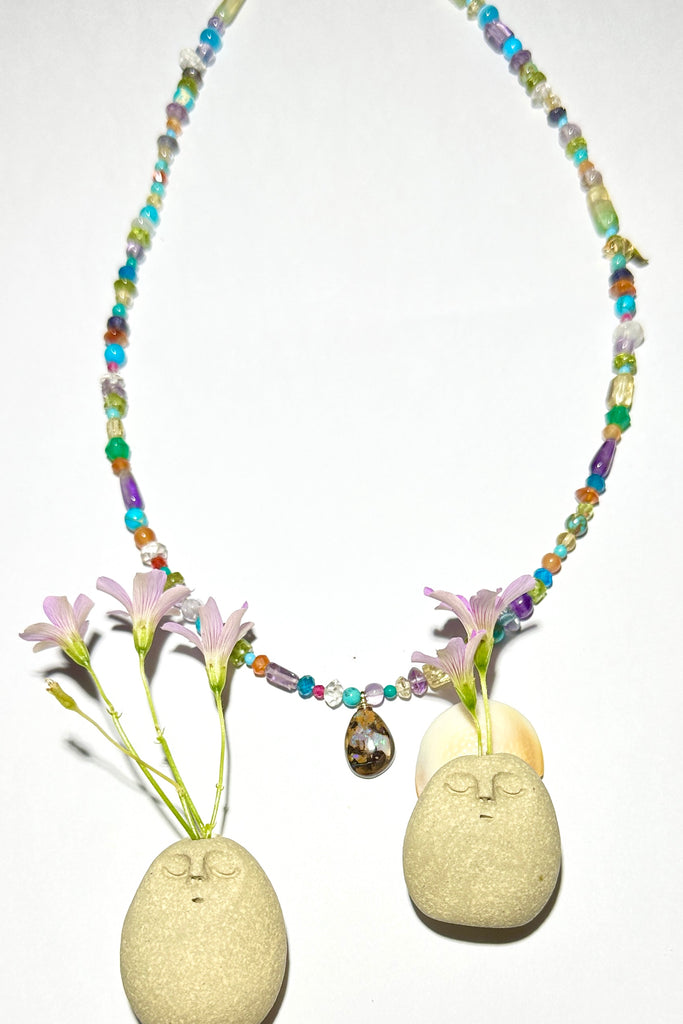 An opal pendant featuring a beautiful delicate whisper of of Australian crystal opal cut and polished to reveal the flecks of colour through the stone. A one of a kind opal. This piece has soft mystical colouring, flecks of green, blue and a little mauve. Australian Crystal Opal.