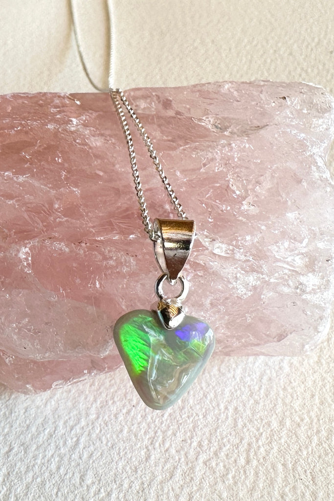 Natural solid Australian Crystal opal. One off piece. This tiny adorable little opal heart pendant has flash of bright green with some gold and blue as well. The surface has a beautiful polish. Comes on a 925 silver chain.
