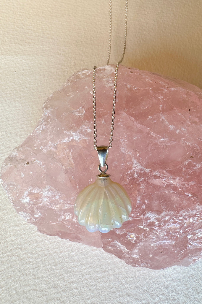 An opal pendant featuring a tiny carved seashell in Australian crystal opal. This is a very softly coloured piece with mauve, green and pink. A one of a kind opal. This piece has soft misty colouring, flecks of green, blue and mauve. Australian Crystal Opal.