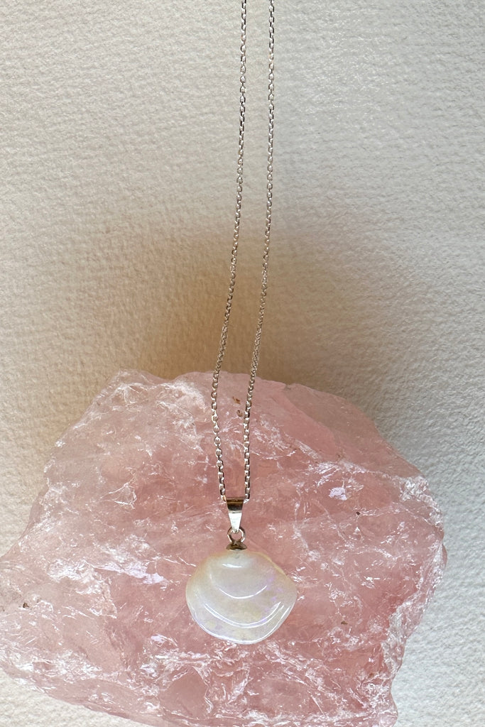 An opal pendant featuring a tiny carved seashell in Australian crystal opal. This is a very softly coloured piece with mauve, green and pink. A one of a kind opal. This piece has soft misty colouring, flecks of green, blue and mauve. Australian Crystal Opal.