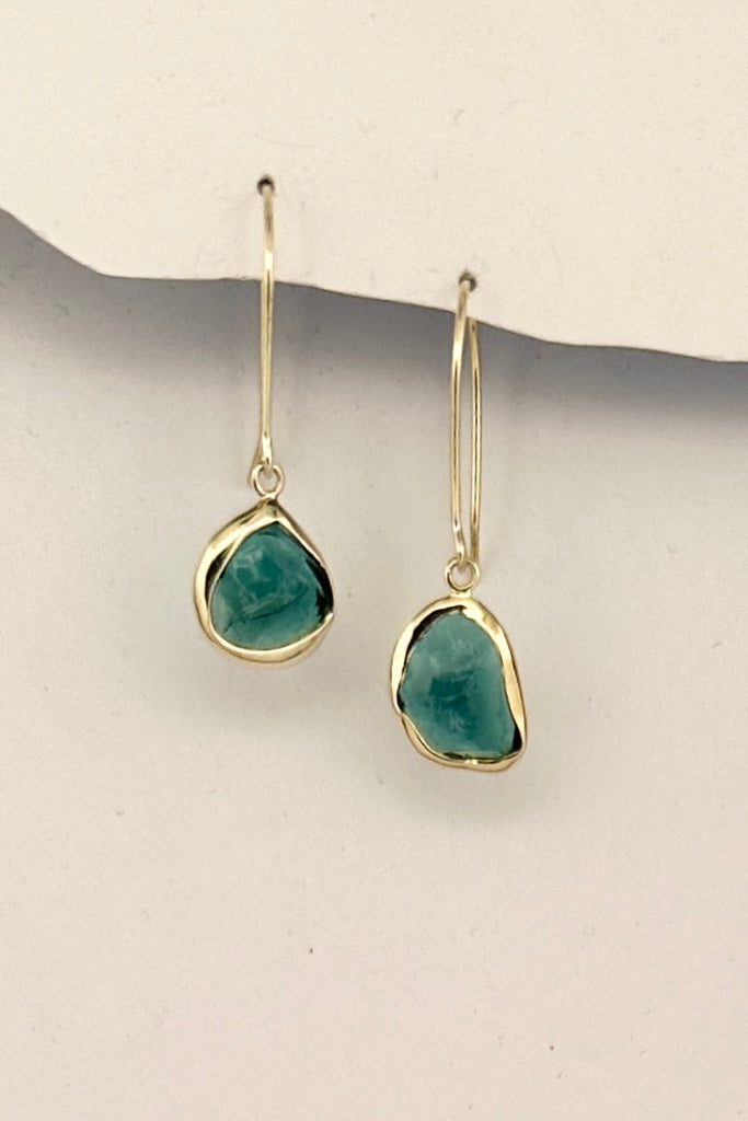 One off earrings made by bezel setting a shard of teal green natural Tourmaline, a very unique style, each side is slightly different. 