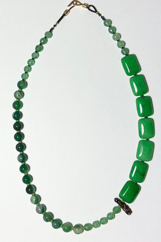 The necklace is made with different shapes of green coloured quartz and green coloured Agate stone with a highlight of a single grey. Hand made exclusively in Australia for Mombasa Rose Boutique, this is a one off piece, there will never be another.