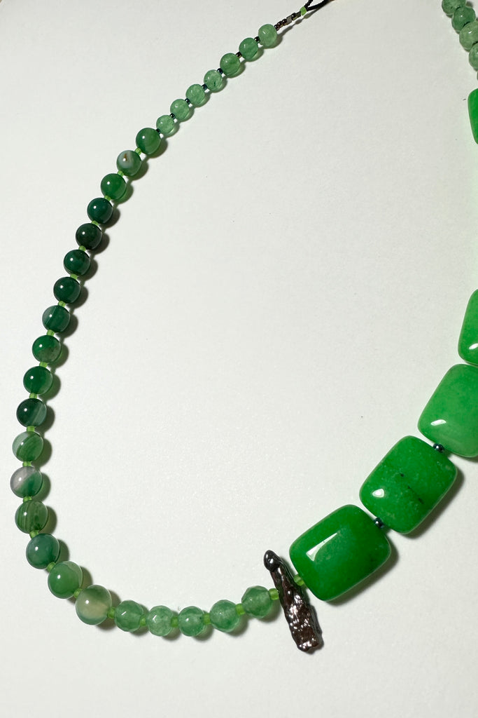 The necklace is made with different shapes of green coloured quartz and green coloured Agate stone with a highlight of a single grey. Hand made exclusively in Australia for Mombasa Rose Boutique, this is a one off piece, there will never be another.