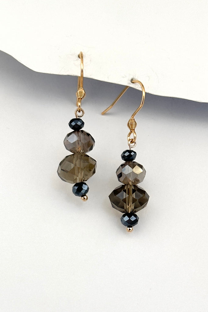 Chic earrings that are a dainty stack of sparkling crystal beads that swing from a goldtone hook. 