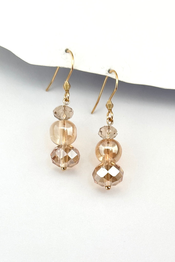 Chic earrings that are a dainty stack of sparkling crystal beads that swing from a goldtone hook. 