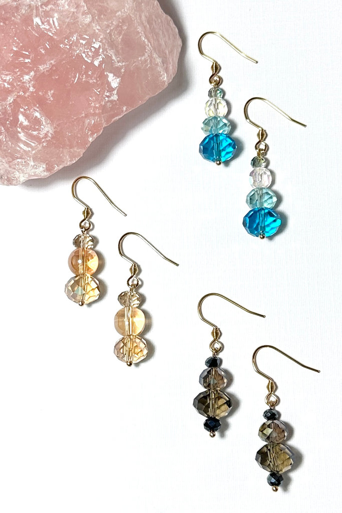 Chic earrings that are a dainty stack of sparkling crystal beads that swing from a goldtone hook. 