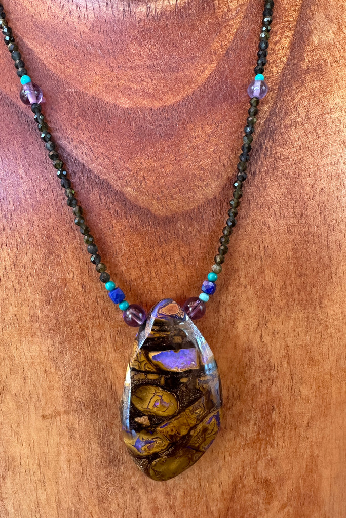 This necklace has been designed using a natural Australian Opal pendant strung on tiny faceted smoky quartz beads, enhanced with natural turquoise, amethyst and lapis lazuli.