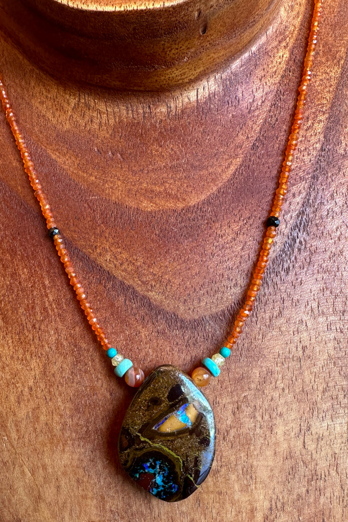 This necklace has been designed using a natural Australian Opal pendant strung on small faceted Carnelian beads, and enhanced with natural Turquoise beads. The stones are all natural semi precious gems, there is a gorgeous harmony achieved that is reminiscent of the colours in the rocks and the water of Australia. T