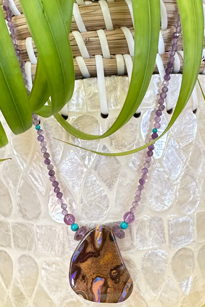 This necklace has been designed using a natural Australian Opal pendant strung on small faceted Amethyst beads enhanced with natural turquoise beads.