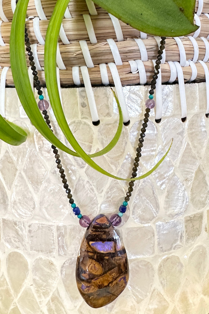 This necklace has been designed using a natural Australian Opal pendant strung on tiny faceted smoky quartz beads, enhanced with natural turquoise, amethyst and lapis lazuli.