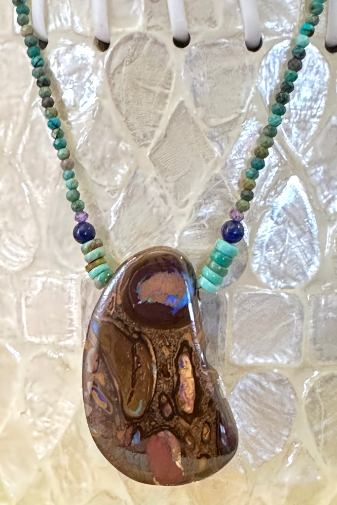 This necklace has been designed using a natural Australian Opal pendant strung on small faceted Natural rough Turquoise beads enhanced with Amethyst and Lapis Lazuli beads.