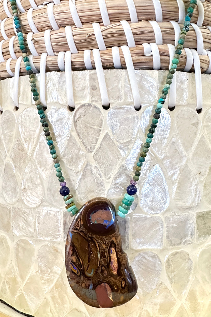 This necklace has been designed using a natural Australian Opal pendant strung on small faceted Natural rough Turquoise beads enhanced with Amethyst and Lapis Lazuli beads.