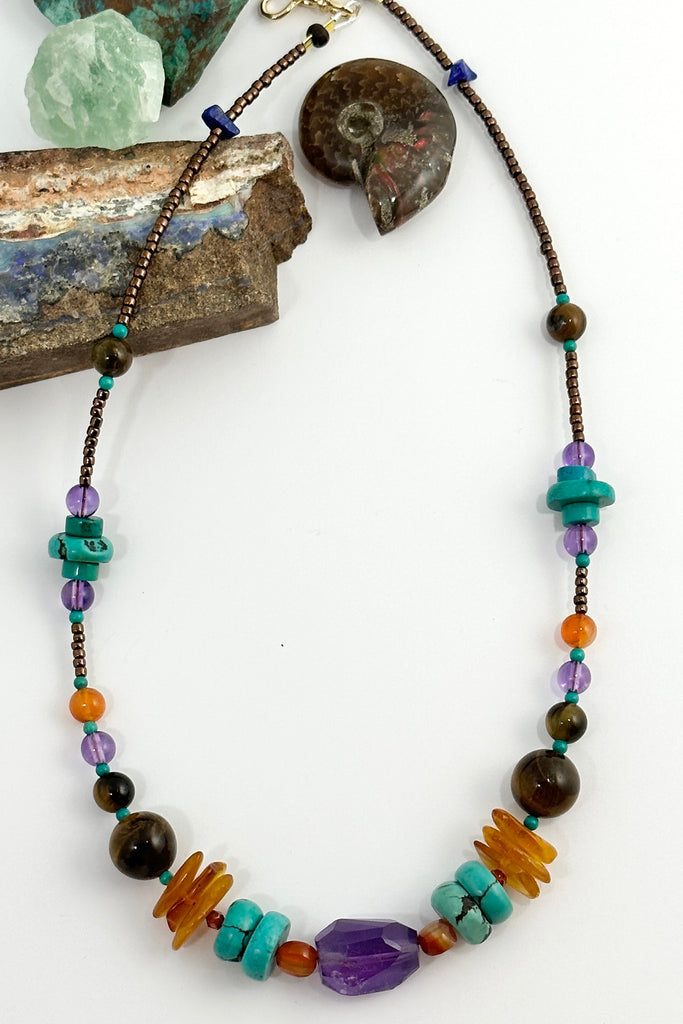42cm in length, which is a necklace designed to be worn at choker length. Beads include Carnelian, natural Turquoise, Amethyst, Lapis Lazuli, Tigers Eye from Africa and Amber.