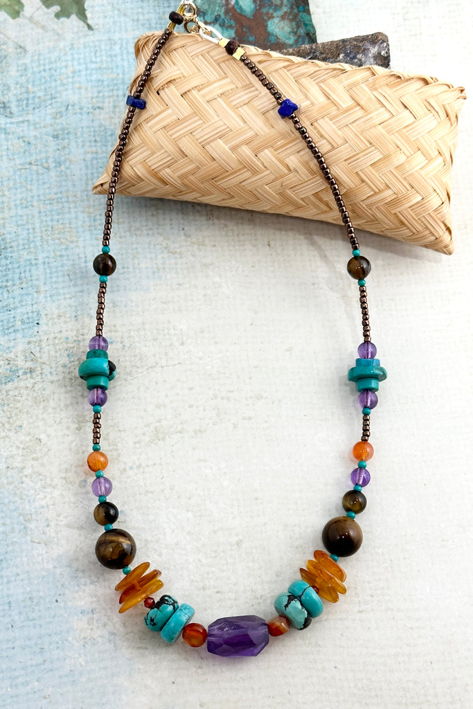 42cm in length, which is a necklace designed to be worn at choker length. Beads include Carnelian, natural Turquoise, Amethyst, Lapis Lazuli, Tigers Eye from Africa and Amber.