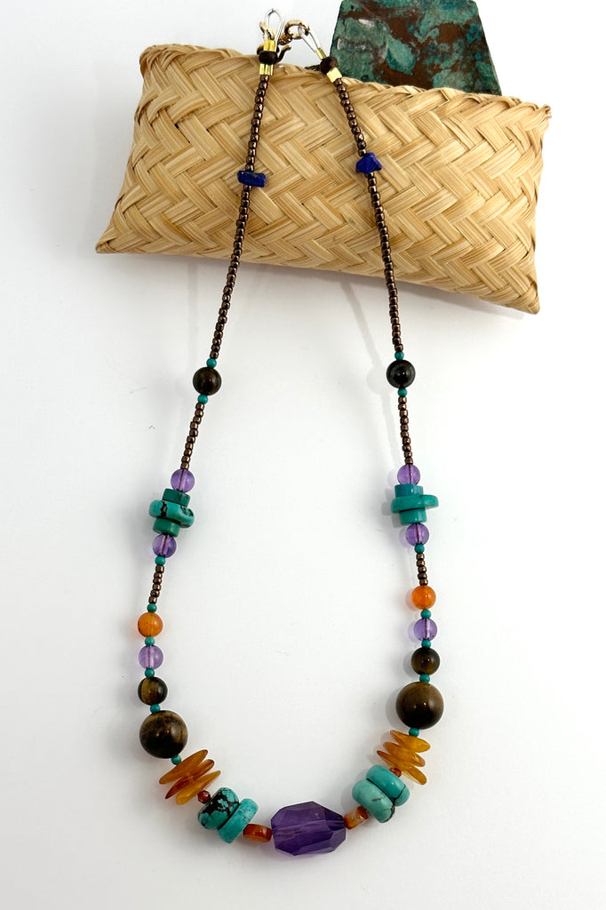 42cm in length, which is a necklace designed to be worn at choker length. Beads include Carnelian, natural Turquoise, Amethyst, Lapis Lazuli, Tigers Eye from Africa and Amber.