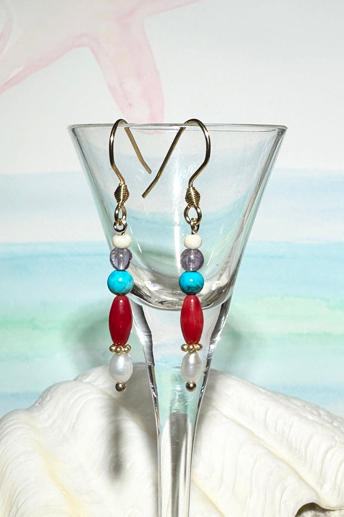 Our Inez gemstone earrings bring together an unusual colour combination, a perfect little swing style to add a pop of colour.

Turquoise Howlite, Amethyst and red bamboo coral, as well as a tiny pearl
