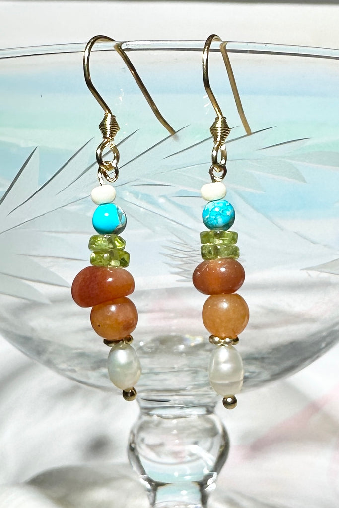 Our Inez gemstone earrings bring together an unusual colour combination, a perfect little swing style to add a pop of colour.

Turquoise Howlite, Carnelian Peridot and red bamboo coral, as well as a tiny pearl.