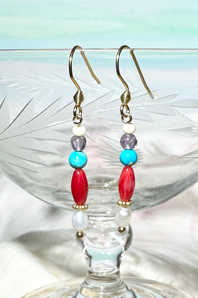 Our Inez gemstone earrings bring together an unusual colour combination, a perfect little swing style to add a pop of colour.

Turquoise Howlite, Amethyst and red bamboo coral, as well as a tiny pearl