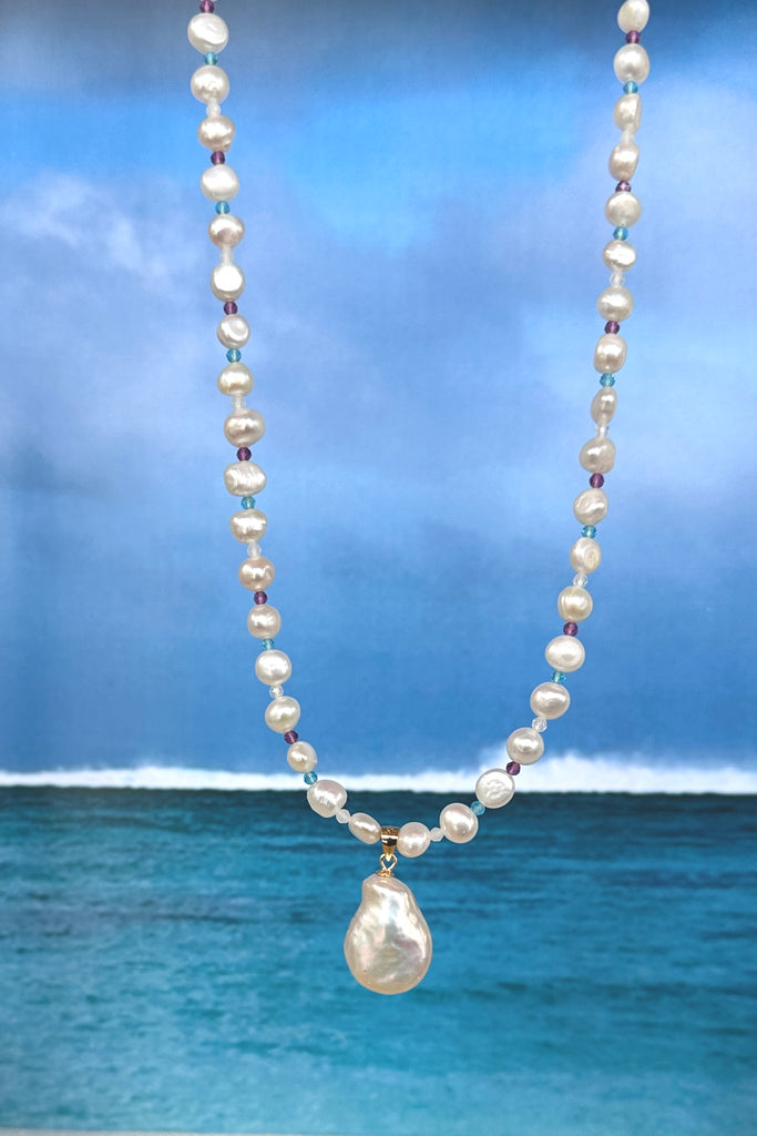 A pearl necklace with a South Pacific twist, luminescent creamy white pearls interspaced with turquoise, pink and white CZ beads, feel the calm of the islands.