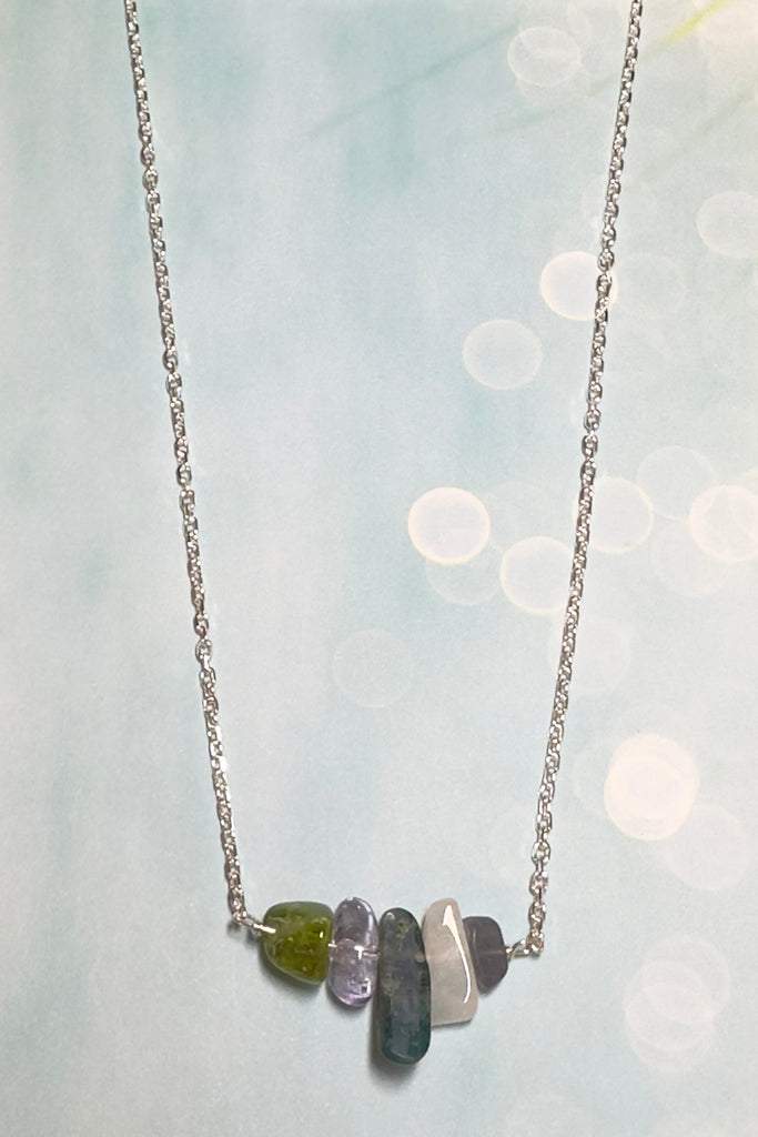 The swing style necklace is designed in a simple and chic style, using rough shards of the semi precious stone Kyanite. 