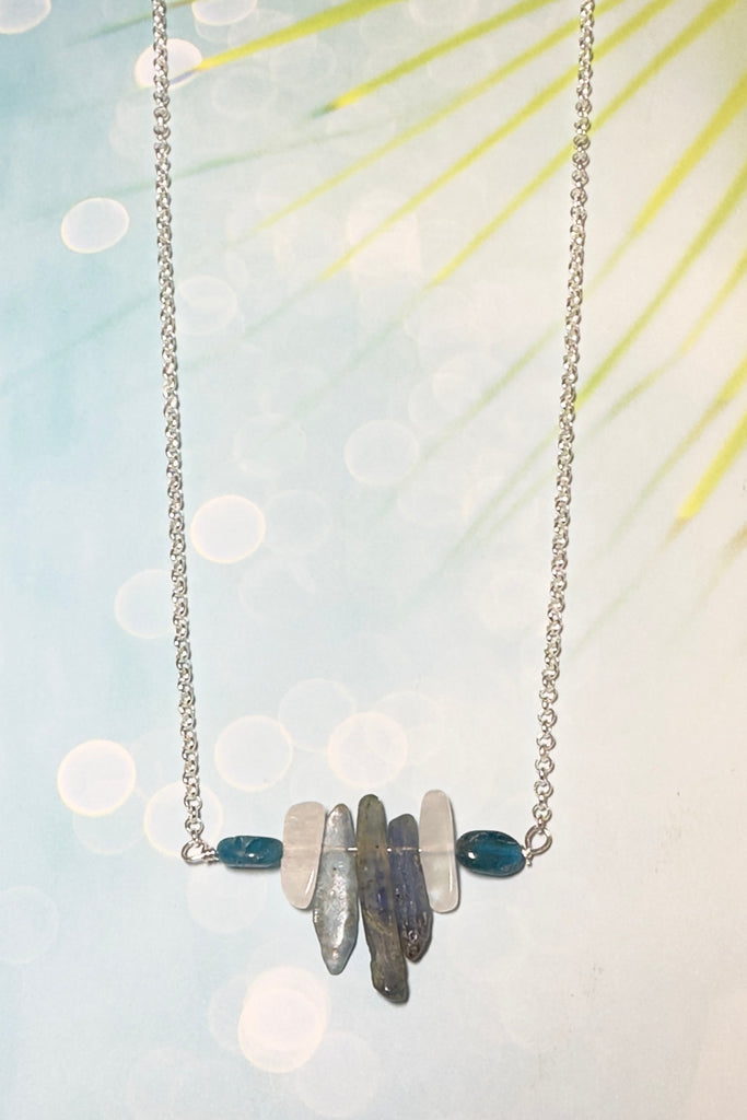 The swing style necklace is designed in a simple and chic style, using rough shards of the semi precious stone Kyanite. 