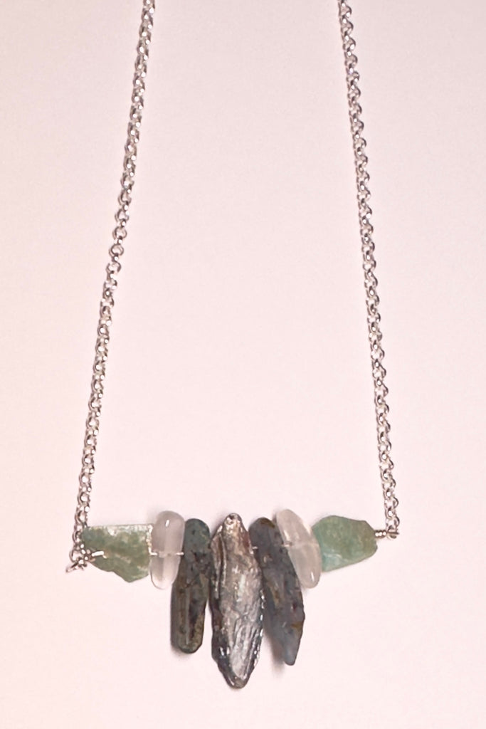 The swing style necklace is designed in a simple and chic style, using rough shards of the semi precious stone Kyanite. 