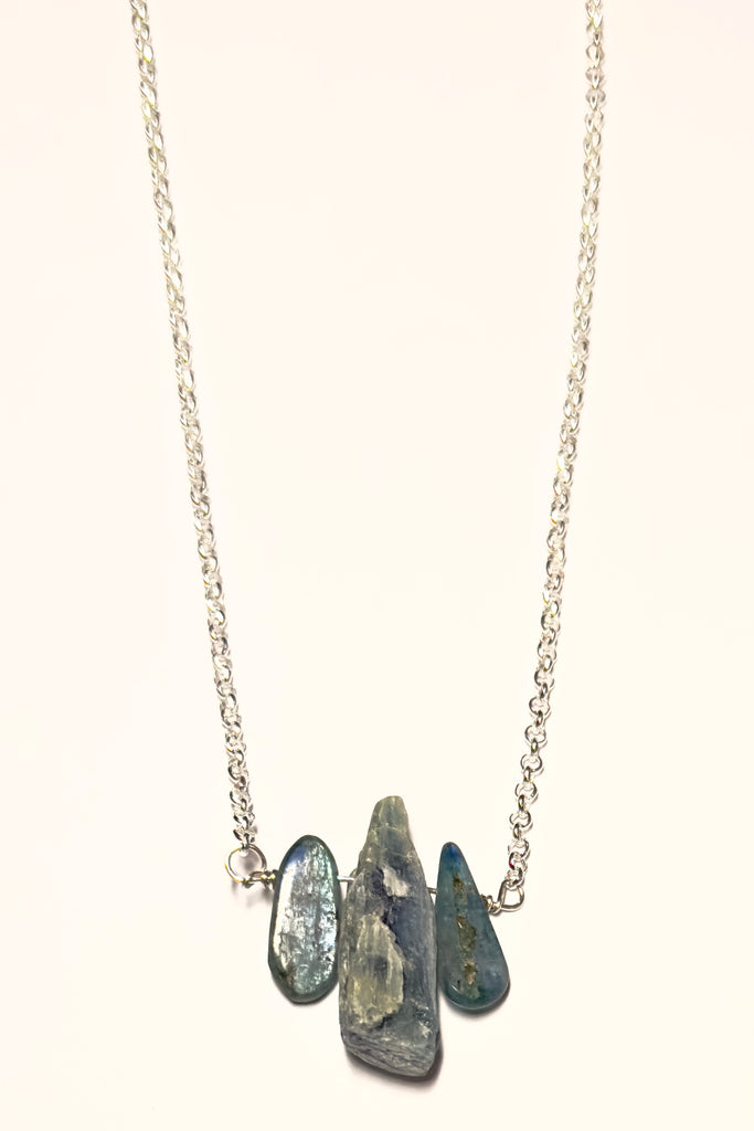 The swing style necklace is designed in a simple and chic style, using rough shards of the semi precious stone Kyanite. 