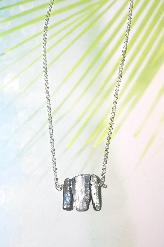 The swing style necklace is designed in a simple and chic style, using rough shards of the semi precious stone Kyanite. 