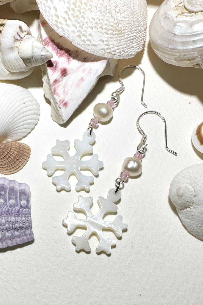 Hand cut Mother of Pearl snowflake earrings.
A small freshwater pearl.