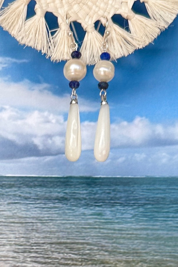 Island chic perfection, so very cool, statement earrings with a shimmery Mother of Pearl droplet swinging from a creamy round pearl.&nbsp;

Freshwater pearls.
Mother of Pearl droplet.