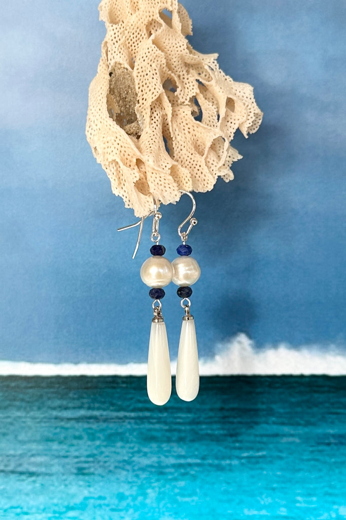 Island chic perfection, so very cool, statement earrings with a shimmery Mother of Pearl droplet swinging from a creamy round pearl.&nbsp;

Freshwater pearls.
Mother of Pearl droplet.