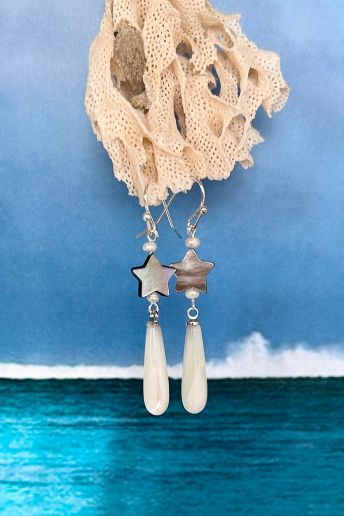 These pretty earrings are island chic perfection, so very cool, a shimmery Mother of Pearl droplet swings from a tiny silvery grey shell star.

Mother of Pearl droplet and hand cut star.
Small pearl accent beads.