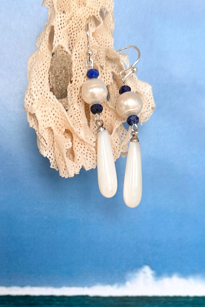 Island chic perfection, so very cool, statement earrings with a shimmery Mother of Pearl droplet swinging from a creamy round pearl.&nbsp;

Freshwater pearls.
Mother of Pearl droplet.