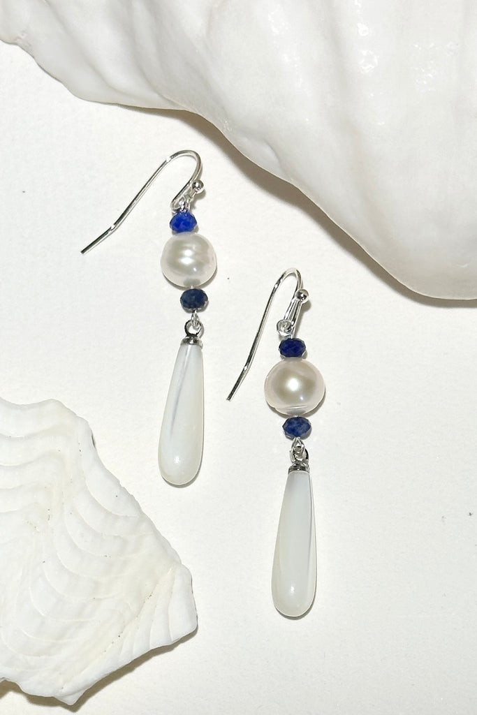 Island chic perfection, so very cool, statement earrings with a shimmery Mother of Pearl droplet swinging from a creamy round pearl.&nbsp;

Freshwater pearls.
Mother of Pearl droplet.