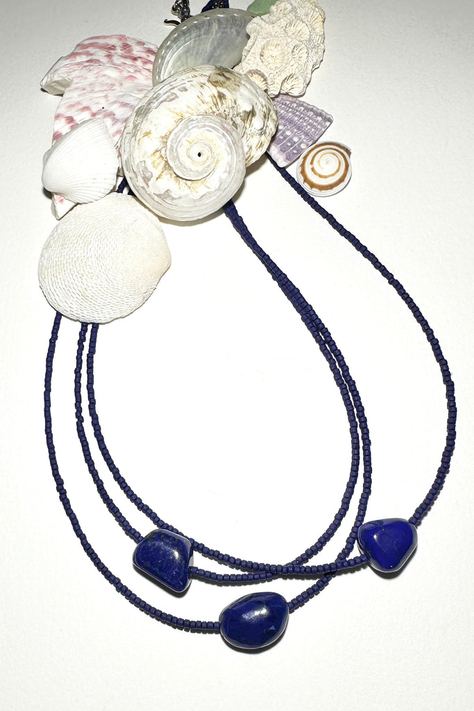 A necklace of blue moon and the sea, a tropical night sky and a luminescent pearl, we are dreaming of cool waters and island romance.


Natural Lapis Lazuli centre bead.
Cobalt blue Afghan "sand" beads.