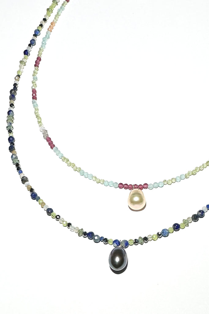 A Pretty pearl strung on a necklace of tiny faceted gemstone beads, Its chic and delicate and perfect for summer.

Freshwater pearl.
Lapis, Peridot, garnet and quartz crystal beads.&nbsp;