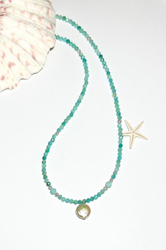 A pearl necklace where tiny pearls float on a thread of faceted Amazonite and pearl beads, inspired by the gentle waves of South Pacific reef lagoon.

Freshwater pearls.
Faceted aqua blue Amazonite beads.