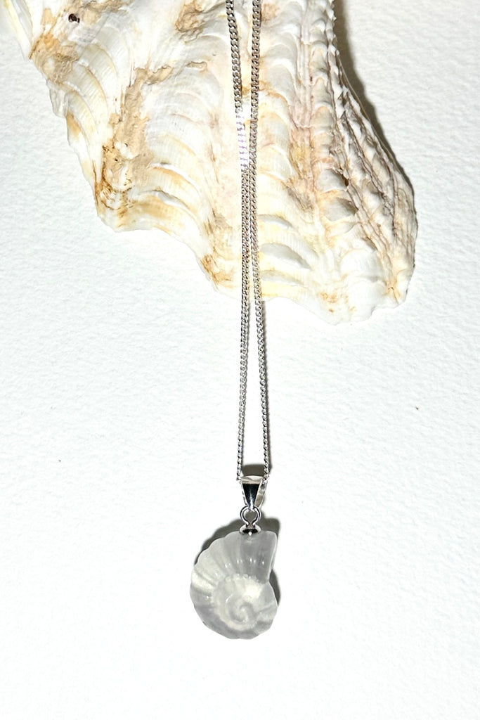 A Fluorite gemstone that has been hand carved into a tiny nautilus sea shell, it has a magical prettiness all of its own.&nbsp;

Fluorite gemstone hand carved into a nautilus sea shell