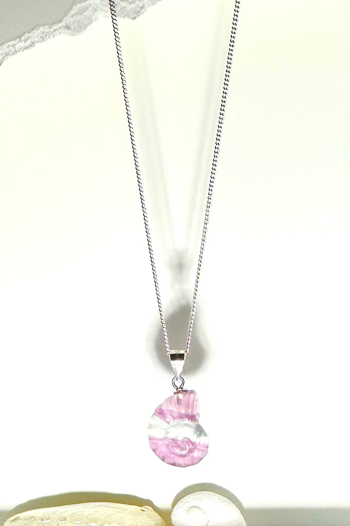 A Fluorite gemstone that has been hand carved into a tiny nautilus sea shell, it has a magical prettiness all of its own.